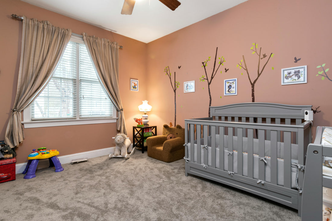 cosy nursery room UK with neutral decor, baby cot, soft lighting and cute wall art ideas
