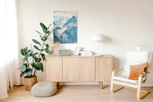 Warm minimalist home decor in a cosy UK living room with neutral tones, wooden furniture and wall art